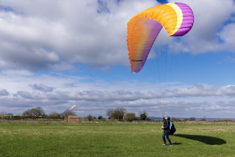 Paraglider in bright sky